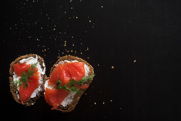Sandwich with salmon and cream cheese. On a piece of rye multi-grain bread. 