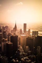 Poster View of buildings across New York City skyline under golden sunset light © littleny