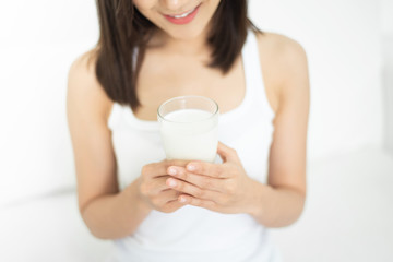 Asian woman drinking milk.