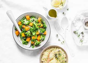 Broccoli, pumpkin warm salad with couscous on a light background, top view. Vegetarian food concept, healthy diet lifestyle. Flat lay