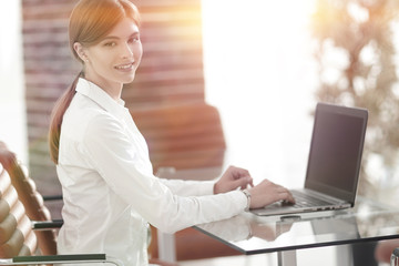 portrait of young woman working with a laptop .