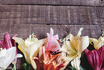 spring background, flowers top view. beautiful colorful lily flower on rustic wooden background....
