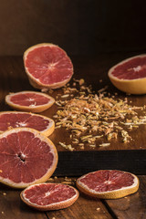 Sliced grapefruit with grated peels in window light