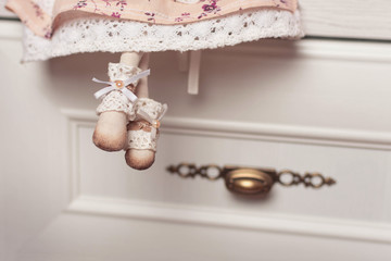 The legs of the interior doll are decorated with lace and beads. Small details of a textile doll.