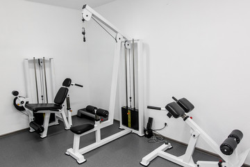 Fototapeta na wymiar modern gym weight training equipment for exercises and rehab for legs and back. rehabilitation equipment in therapy clinic. fitness wellness concept. space for text