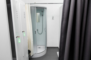 shower room with cabin and lockers in physiotherapy rehab clinic. modern rehabilitation equipment. fitness wellness hygiene concept. space for text