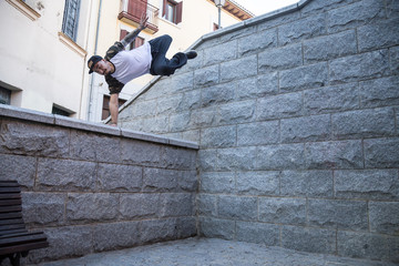 Young man doing an amazing parkour trick on the street. 