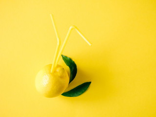 Summer creative background. lemon on a yellow background. Flat lay, top view, copy space 