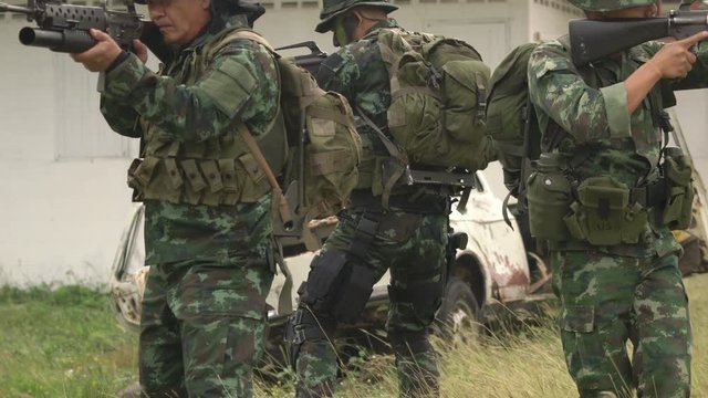 Soldier holding gun weapon and waring armor uniform. The military is responsible for maintaining the territory.
