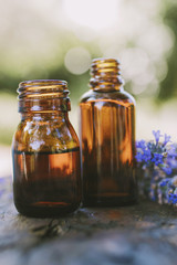 oil jars or lavender essence with a bouquet of natural lavender flowers