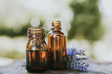 oil jars or lavender essence with a bouquet of natural lavender flowers