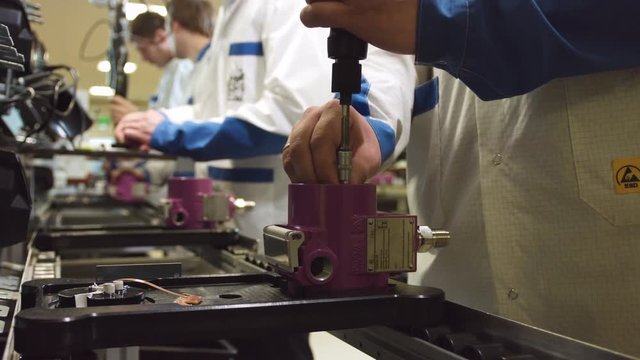 meter production line and workers assemble devices