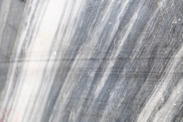 Gray surface of marble stone with striped streaks.