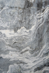 Fototapeta premium Gray surface of marble stone with striped streaks.