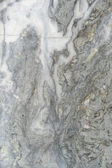 Gray surface of marble stone with striped streaks.