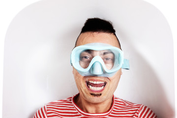 man with a diving mask in the water of a bathtub