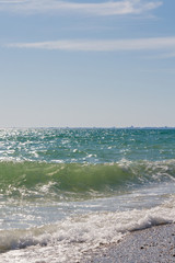 Beach with a wave in the summer Sunny day