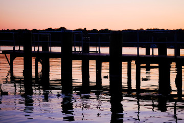 Fototapeta premium Landscape with lake and pier at sunset