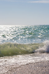 Beach with a wave in the summer Sunny day