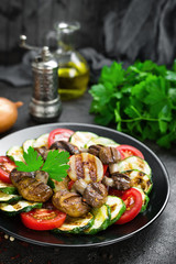 Salad with fresh and grilled vegetables and mushrooms. Vegetable salad with grilled champignons. Vegetable salad on plate