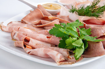 Assorted homemade meat platter with sauce and mustard
