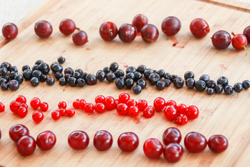 Flatlay with raspberries, blueberries and gooseberries.