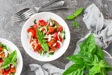 Vegetable salad with fresh tomato, basil and onion
