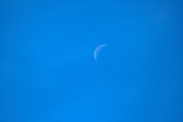 Obraz na płótnie Canvas A moon in a blue sky.