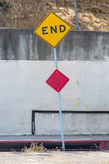 A yellow End sign at the end of a dead end street in Los Angeles