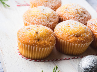 Christmas baking concept - muffins with icing sugar and festive winter decorations