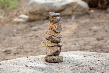 Fototapeta na wymiar A series of stacked rock on top of a boulder at the campground