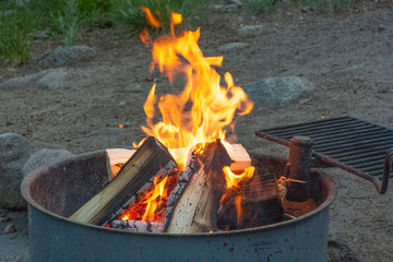Campfire burning on a summer night camping with the family at the campground.