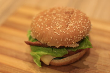 hamburger lying on a wooden table