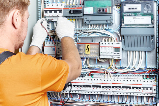 An electrical engineer checks the parameters of the electrical panel.