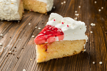 Strawberry Cake dessert with candies on wooden background