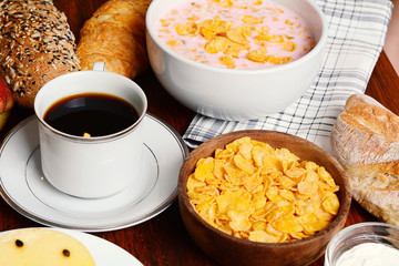 Close up of passion fruit cake, toast, coffee, yogurt, cereals.