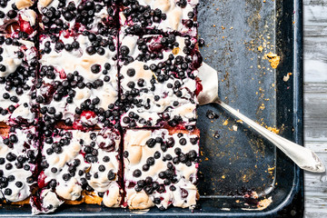Cherry and black berry cake on backing plate and paddle. View from the top. Top view.