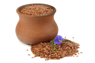 clay pot with flax seeds and flower isolated on white background. flaxseed or linseed. Cereals.