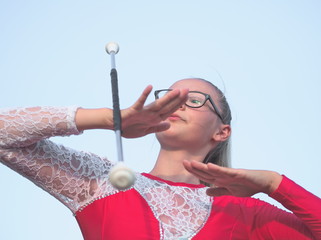 Teen Majorette Girl Twirling Baton Outdoors