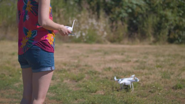 Slow-motion footage of a woman starting the propellers on a drone.  Shot on a Blackmagic Ursa Mini Pro 4.6k with a Sigma 50-100mm f/1.8.