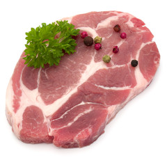 Raw pork neck chop meat with parsley herb leaves and peppercorn spices garnish isolated on white background cutout