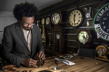 Owner of clock repair shop in New York City working on an old clock