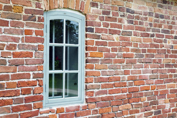 a window in an old brick house

