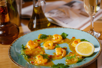 Cooked shrimps served with lemon and sauce . Seafood. 