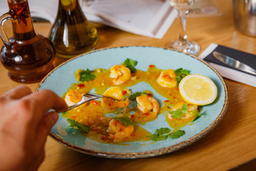 Cooked shrimps served with lemon and sauce . Seafood. 