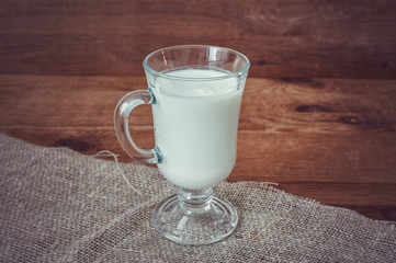 Glass of kefir on a wooden table