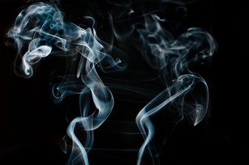 Beautiful white and blue smoke against black backdrop, man and woman shape, motion blur