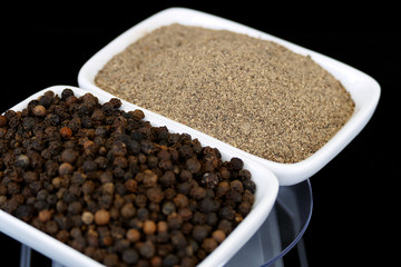 ground black pepper powder and pepper grains,kitchen and black pepper

