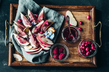 Healthy breakfast bowl  with yogurt, fresh figs and frozen berries