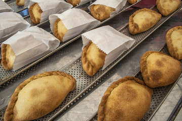 Bolivian Saltenas, traditional bolivian meat and potatoe baked food in market